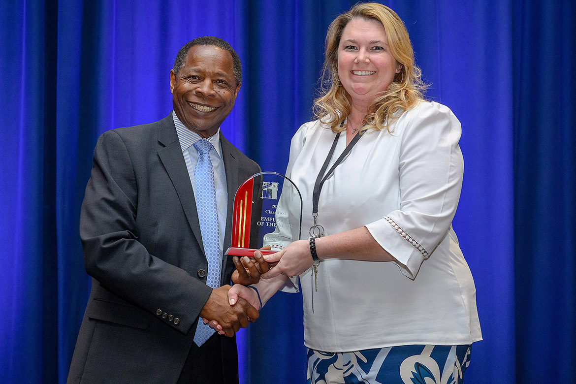 Middle Tennessee State University President Sidney A. McPhee, left, presents the 2025-26 Classified Employee of the Year Award to Sarah Pruitt, coordinator in the Department of Social Work, at the annual Employee Recognition Awards held Wednesday, April 22, in the James Union Building on campus in Murfreesboro, Tenn. (MTSU photo by Andy Heidt)