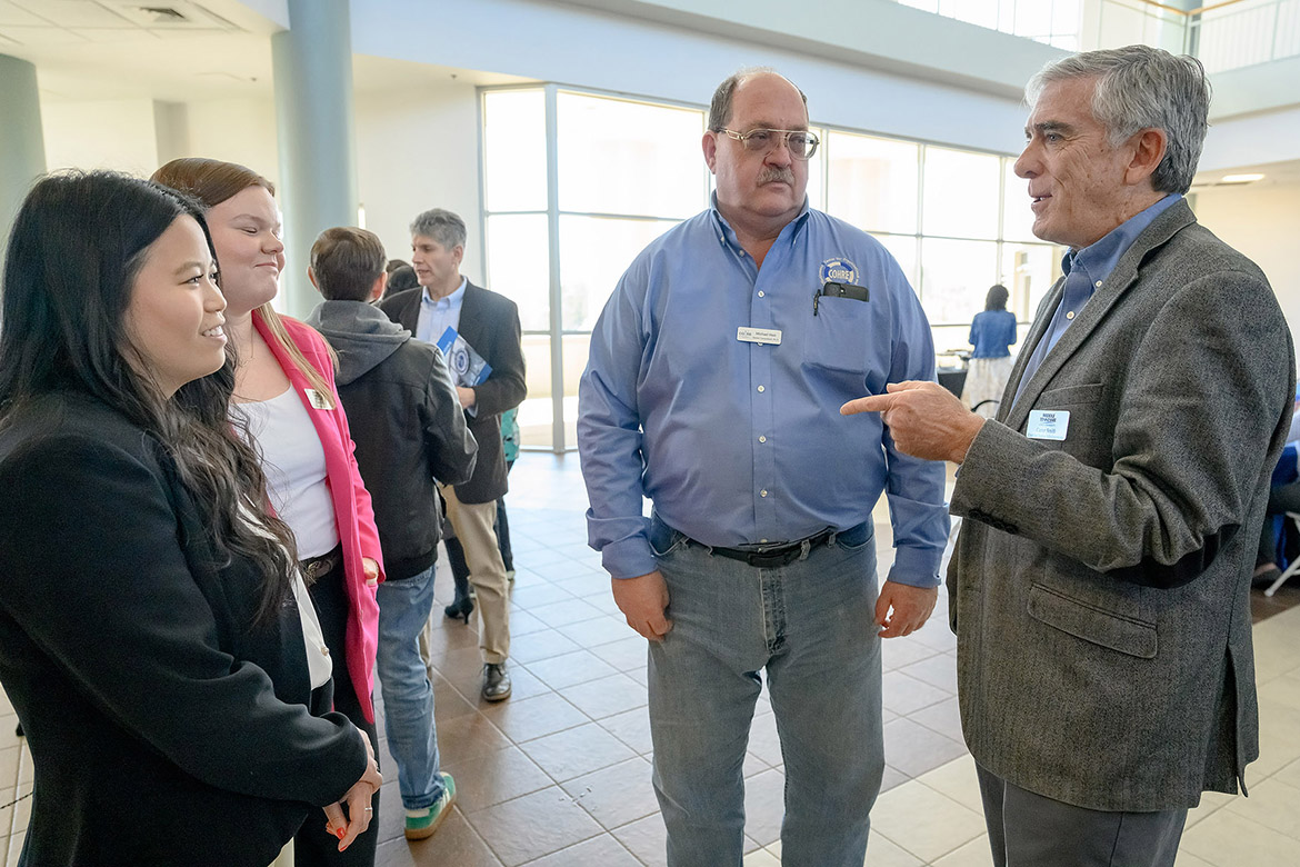 Carter Smith, associate professor of criminal justice, right, and Michael Hein, industrial-organizational psychology program professor, talk with students about the interdepartmental collaboration that is helping rewrite Tennessee law enforcement officer training academy curriculum. The project, “Training Future Law Enforcement,” was a featured presentation at the Faculty Showcase held in March at Miller Education Center following the quarterly MTSU Board of Trustees meeting. (MTSU photo by J. Intintoli)