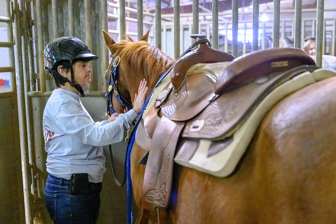 Sharon, a participant in the Center for Equine Recovery for Veterans at Middle Tennessee State University in Murfreesboro, Tenn., pats one of the horses she’s riding throughout the 10-week program. The equine therapy program is possible through a partnership between MTSU and the VA Tennessee Valley Healthcare System to help veterans in their recovery journeys. (MTSU photo by J. Intintoli)