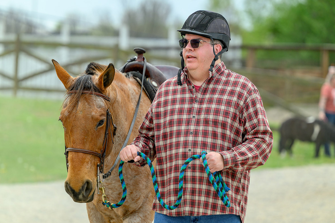 Steve, a participant in the Middle Tennessee State University Center for Equine Recovery for Veterans, holds lead rope of his horse during a therapy session held recently at the MTSU Horse Science Center in Murfreesboro, Tenn. The 10-week program is made possible through a partnership with MTSU and the VA Tennessee Valley Healthcare System to help veterans in their recovery journeys. (MTSU photo by J. Intintoli)