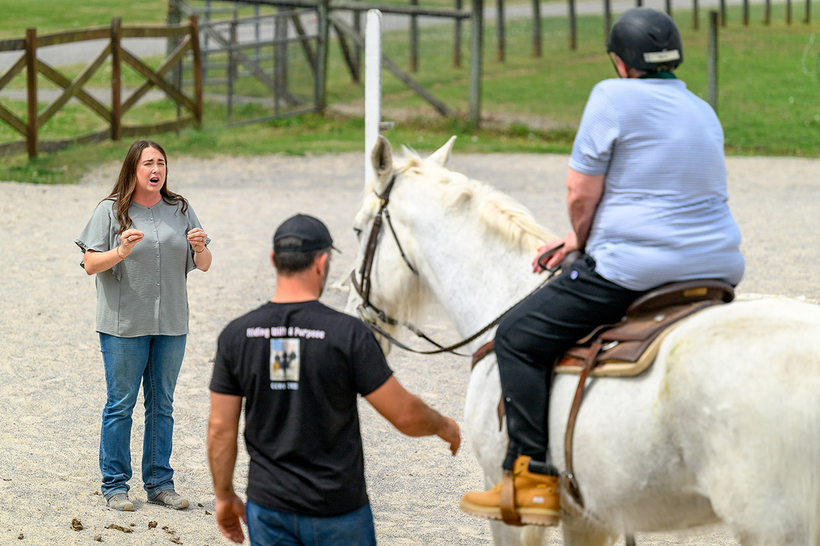 Andrea Rego, left, coordinator of the Center for Equine Recovery for Veterans, or CERV, and a senior instructor in the School of Agriculture at Middle Tennessee State University in Murfreesboro, Tenn., gives instructions to participants in the equine therapy program during a recent session. The 10-week program is possible through a partnership with MTSU and the VA Tennessee Valley Healthcare System to help veterans in their recovery journeys. (MTSU photo by J. Intintoli)