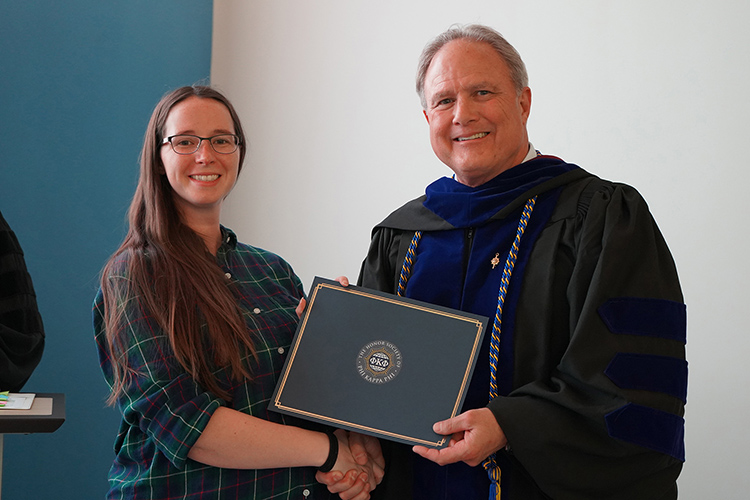 Middle Tennessee State University student and Phi Kappa Phi initiate Sarah Gentzler, left, with College of Behavioral and Health Sciences Dean Peter Grandjean at the Spring 2026 initiation ceremony at the Paul W. Martin Sr. Honors Building. (MTSU photo by Robin E. Lee)