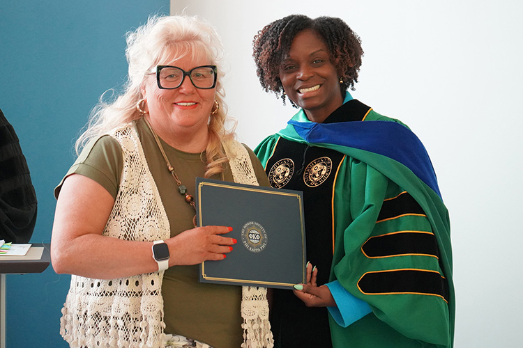 Middle Tennessee State University student and Phi Kappa Phi initiate Lisa Butts, left, is shown with College of Education Dean Neporcha Cone at the Spring 2026 initiation ceremony at the Paul W. Martin Sr. Honors Building. (MTSU photo by Robin E. Lee)