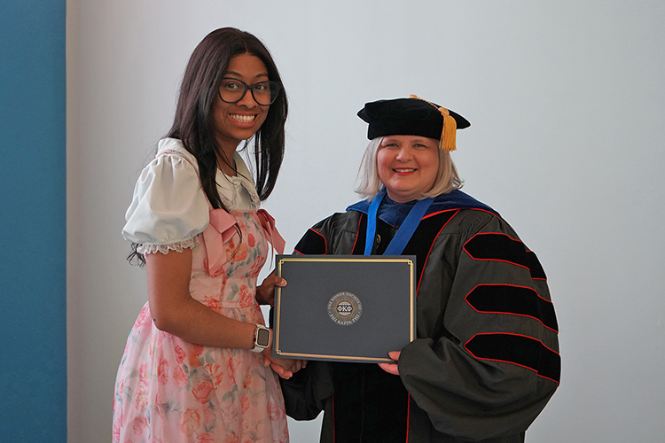 Middle Tennessee State University student and Phi Kappa Phi initiate Mekiah Hayslett, left, is shown with College of Liberal Arts Associate Dean Meredith Dye at the Spring 2026 initiation ceremony at the Paul W. Martin Sr. Honors Building. (MTSU photo by Robin E. Lee)