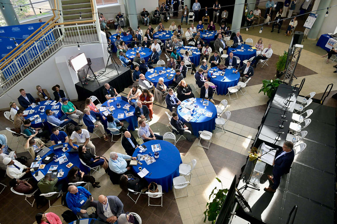 Middle Tennessee State University Provost Mark Byrnes, on stage bottom right, explains how MTSU has integrated technology into its curriculum during welcoming remarks at the Tech Vision 2026 conference held April 10 at the Miller Education Center on campus in Murfreesboro, Tenn. (MTSU photo by Andy Heidt)