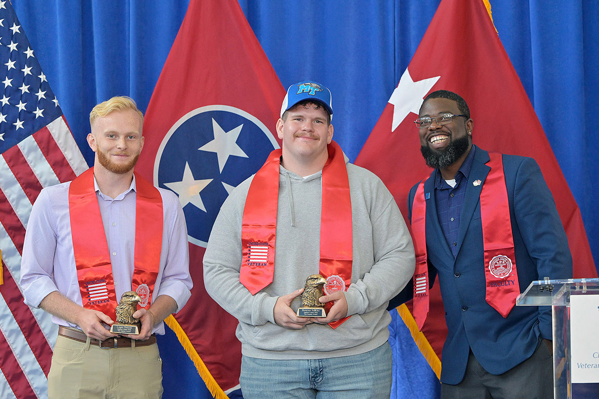 Chris Rochelle, at right, assistant director of the Charlie and Hazel Daniels Veterans and Military Family Center at Middle Tennessee State University in Murfreesboro, Tenn., stands next to Journey Award recipients Logan Duncan, at left, aerospace major from Lafayette, Tenn., and Brennan Judkins, exercise science major from Cross Plains, Tenn., at the 33rd Graduating Veterans Stole Ceremony held Thursday, May 7, 2026, at Miller Education Center. (MTSU photo by Andy Heidt)