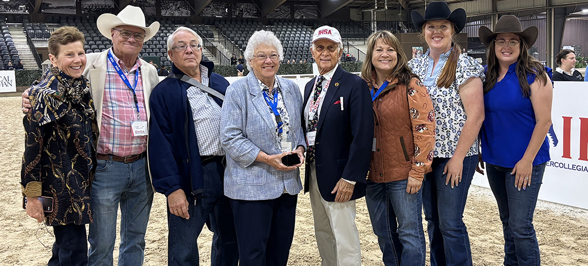 A smiling Anne Brzezicki, center left, Middle Tennessee State University’s prolific former director of Equestrian programs, equestrian team coach and horse science instructor, holds the award she received as an inductee during the Intercollegiate Horse Show Association’s Hall of Fame Induction Ceremony held during the association’s 2026 National Championships, Friday, May 1, at the Tryon International Equestrian Center in Mill Spring, N.C. Pictured, from left, are Tara Boyce, Brzezicki’s 1972 teammate; Peter Cashman, IHSA’s executive director; Michael Brzezicki, her husband; Brzezicki; Bob Cacchione, IHSA founder; Rhonda Hoffman, director of MTSU’s Horse Science program; Ariel Higgins, MTSU’s director of Equestrian programs; and Andrea Rego, director of MTSU’s Center of Equine Recovery for Veterans and the university’s Stock Horse team coach. (Submitted photo)