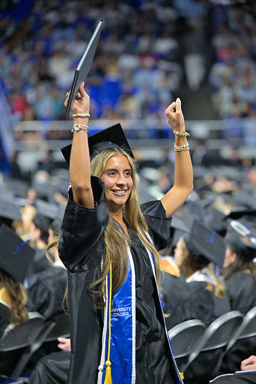 A Middle Tennessee State University spring 2026 graduate shows excitement as she holds up her newly obtained degree during the May 8 commencement ceremony held in Murphy Center on the MTSU campus in Murfreesboro, Tenn. (MTSU photo by Andy Heidt)