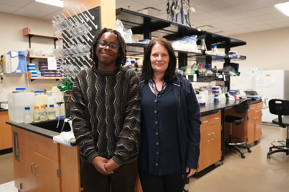 Donye Asberry, left, a biochemistry major, standing next to faculty mentor April Weissmiller, right, associate professor of biology, inside science lab.