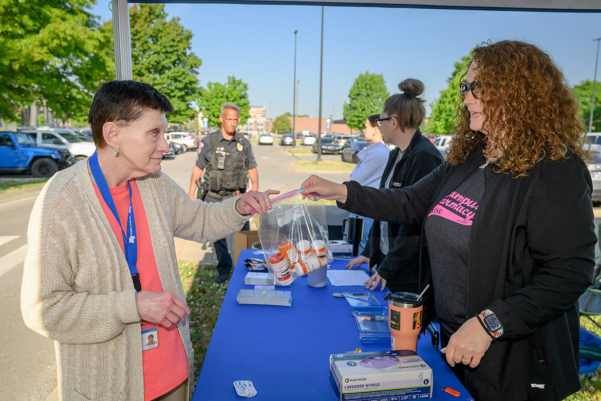 Tabby Ragland, right, director of Campus Pharmacy at Middle Tennessee State University in Murfreesboro, Tenn., accepts a bag of outdated medications from employee Pat Grimes as part of the biannual MTSU Drug-Vape Take-Back event held on campus Thursday, March 23. MTSU hosts the event as part of the Drug Enforcement Agency’s national initiative aimed at providing a safe, convenient and environmentally responsible way to dispose of unneeded medications while also educating about the abuse of prescription drugs. (MTSU photo by J. Intintoli)