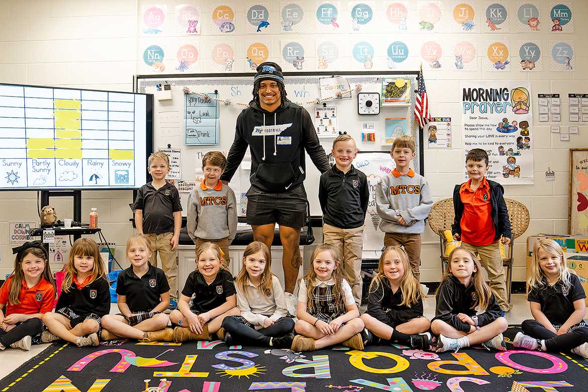 Elijah Carney, a senior philosophy and religious studies major at Middle Tennessee State University in Murfreesboro, Tenn., and linebacker for the Blue Raiders football team takes a photo with students from Middle Tennessee Christian School in Murfreesboro during Read Across America Week. During the visit, Carney read books to the children and emphasized the importance of reading. (Submitted photo)