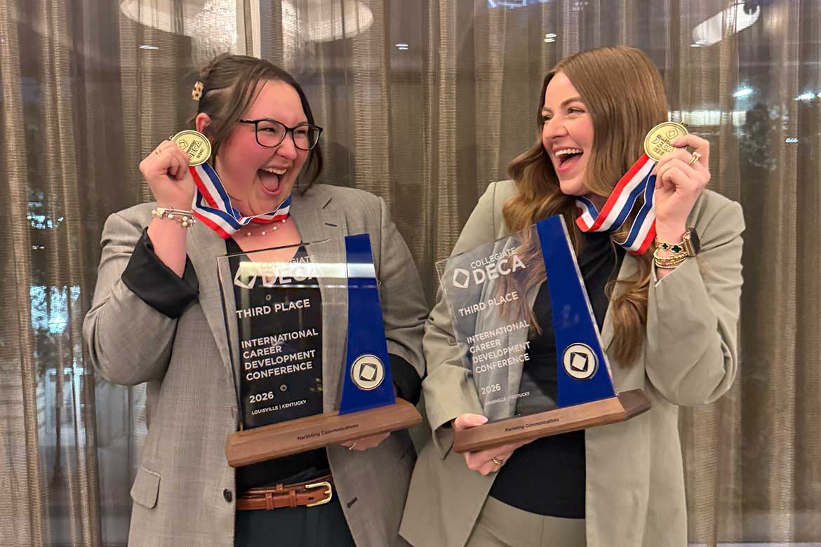 Savanah Gill, left, and Ella Cobb, both Jones College of Business students at Middle Tennessee State University in Murfreesboro, Tenn., are all smiles holding their medallions and glass trophies they received after placing third at the Collegiate DECA Marketing Communications competition during the International Career Development Conference held in Louisville, Kentucky, in April. (Photo submitted)