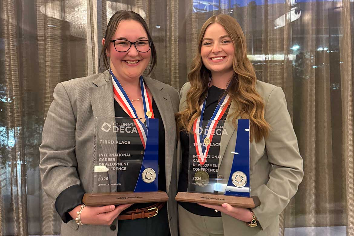 Savanah Gill, left, and Ella Cobb, both Jones College of Business students at Middle Tennessee State University in Murfreesboro, Tenn., are all smiles holding their medallions and glass trophies they received after placing third at the Collegiate DECA Marketing Communications competition during the International Career Development Conference held in Louisville, Kentucky, in April. (Photo submitted)