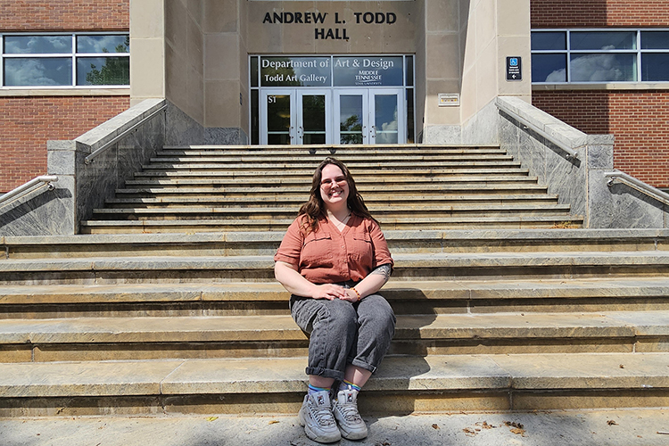 Hannah Middleton sitting on the steps outside Todd Hall.