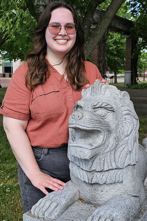 Hannah Middleton standing next to lion sculpture at MTSU.