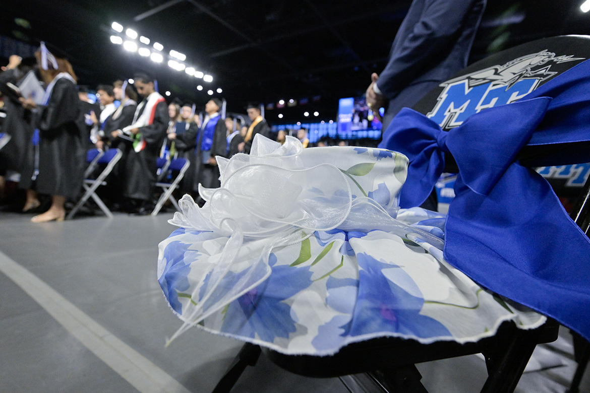 One of the signature hats of the late Elizabeth “Liz” McPhee, first lady of Middle Tennessee State University and wife of 45 years to university President Sidney A. McPhee, rests on her traditional seat, reserved with a blue ribbon, during the Friday, May 8, spring commencement ceremony inside Murphy Center on campus in Murfreesboro, Tenn. Mrs. McPhee died in early January after a brief illness. (MTSU photo by Andy Heidt)