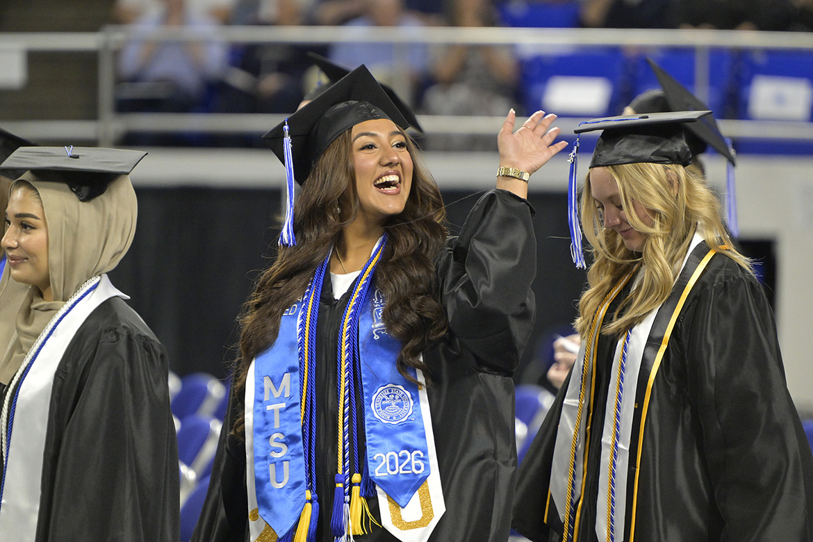 A proud Class of 2026 graduate waves to a supporter during the Friday, May 8, spring commencement ceremony inside Murphy Center.