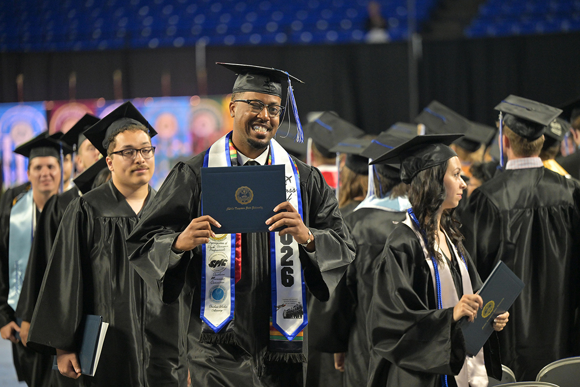 A proud Class of 2026 graduate holds up his diploma cover during the Friday, May 8, spring commencement ceremony inside Murphy Center at Middle Tennessee State University.