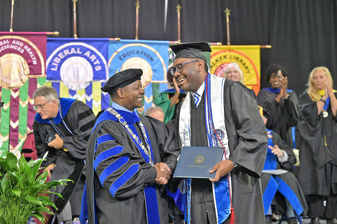 Middle Tennessee State University President Sidney A. McPhee shakes hands with Student Government Association President R.J. Ware of Hermitage, Tenn., after receiving his diploma during the morning commencement ceremony held Saturday, May 9, at Murphy Center on campus in Murfreesboro, Tenn. (MTSU photo by James Cessna)