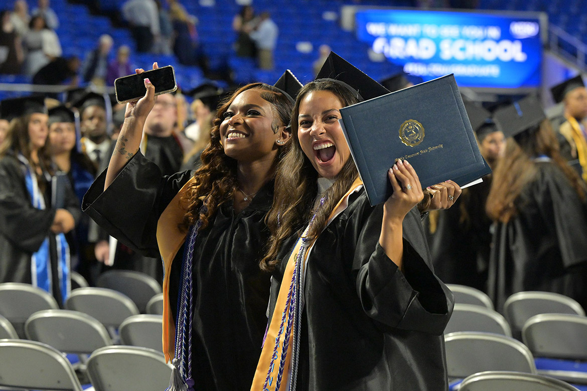 Two Middle Tennessee State University Class of 2026 graduates hug after receiving their diplomas during the morning commencement ceremony held Saturday, May 9, inside Murphy Center on campus in Murfreesboro, Tenn. (MTSU photo by James Cessna)