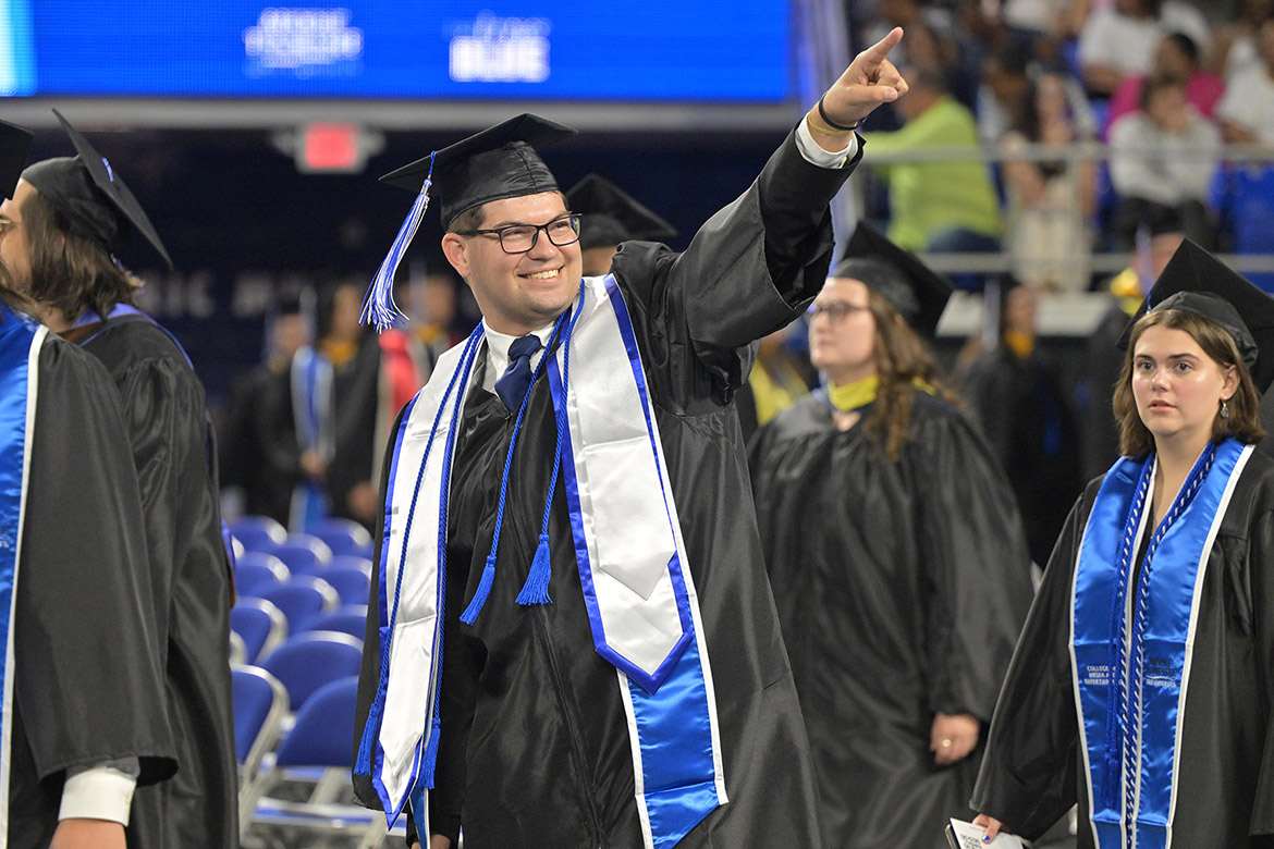 A Class of 2026 graduate points to his supporters during the afternoon commencement ceremony held Saturday, May 9, inside Murphy Center at Middle Tennessee State University in Murfreesboro, Tenn. (MTSU photo by James Cessna)