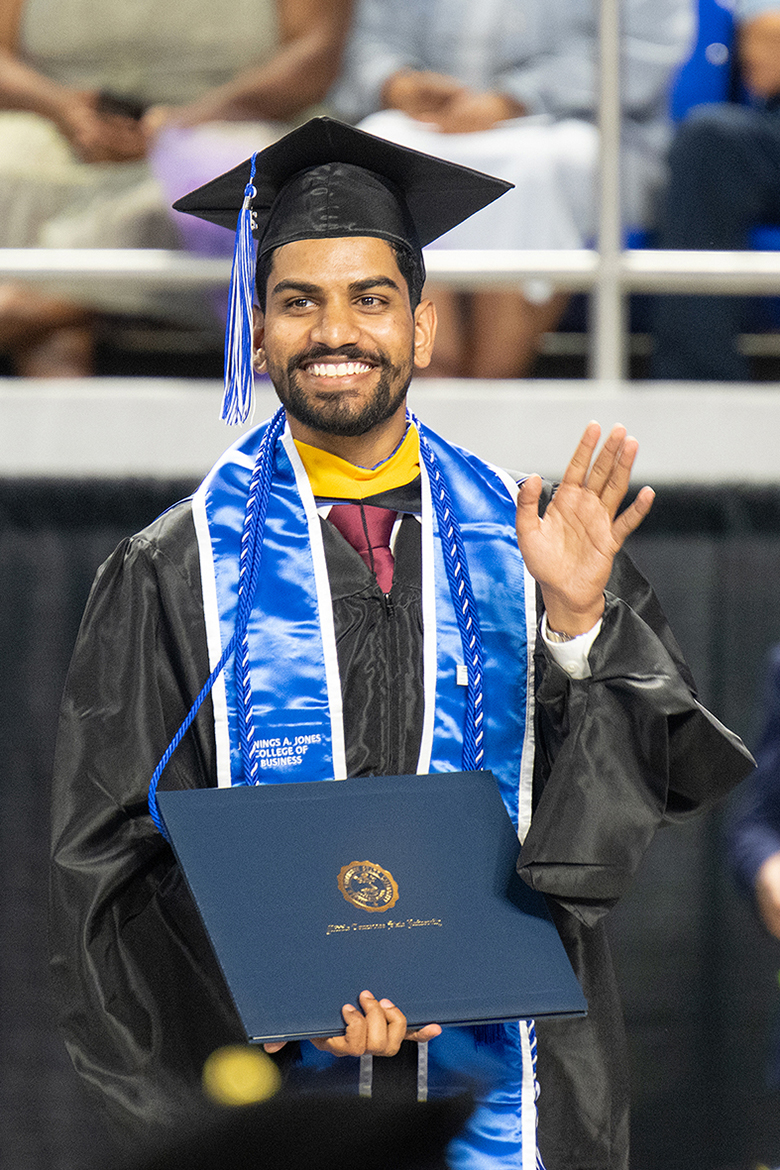 A proud Class of 2026 graduate waves to supporters after being awarded his diploma during the afternoon commencement ceremony held Saturday, May 9, inside Murphy Center at Middle Tennessee State University in Murfreesboro, Tenn. (MTSU photo by Cat Curtis Murphy)