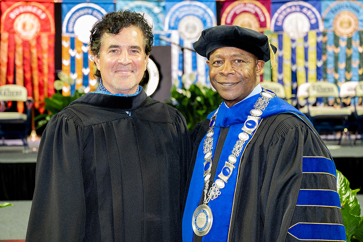 Wearing academic regalia, Middle Tennessee State University President Sidney A. McPhee, right, stands with Big Machine Records founder and CEO Scott Borchetta.