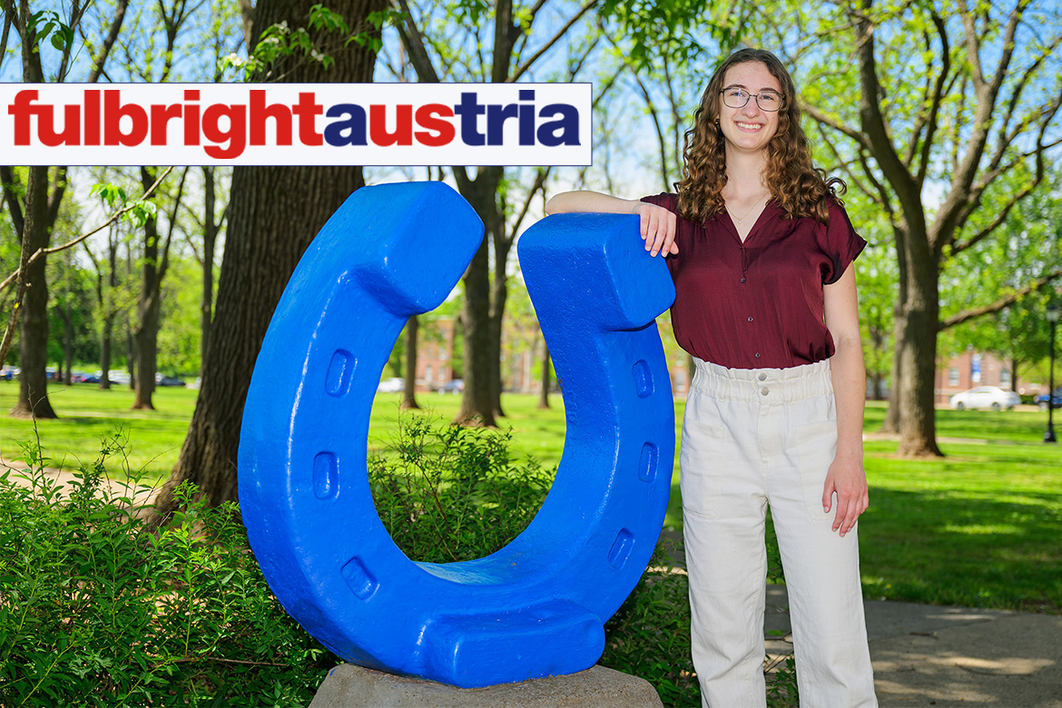 Student standing next to blue horseshoe in Walnut Grove at MTSU.