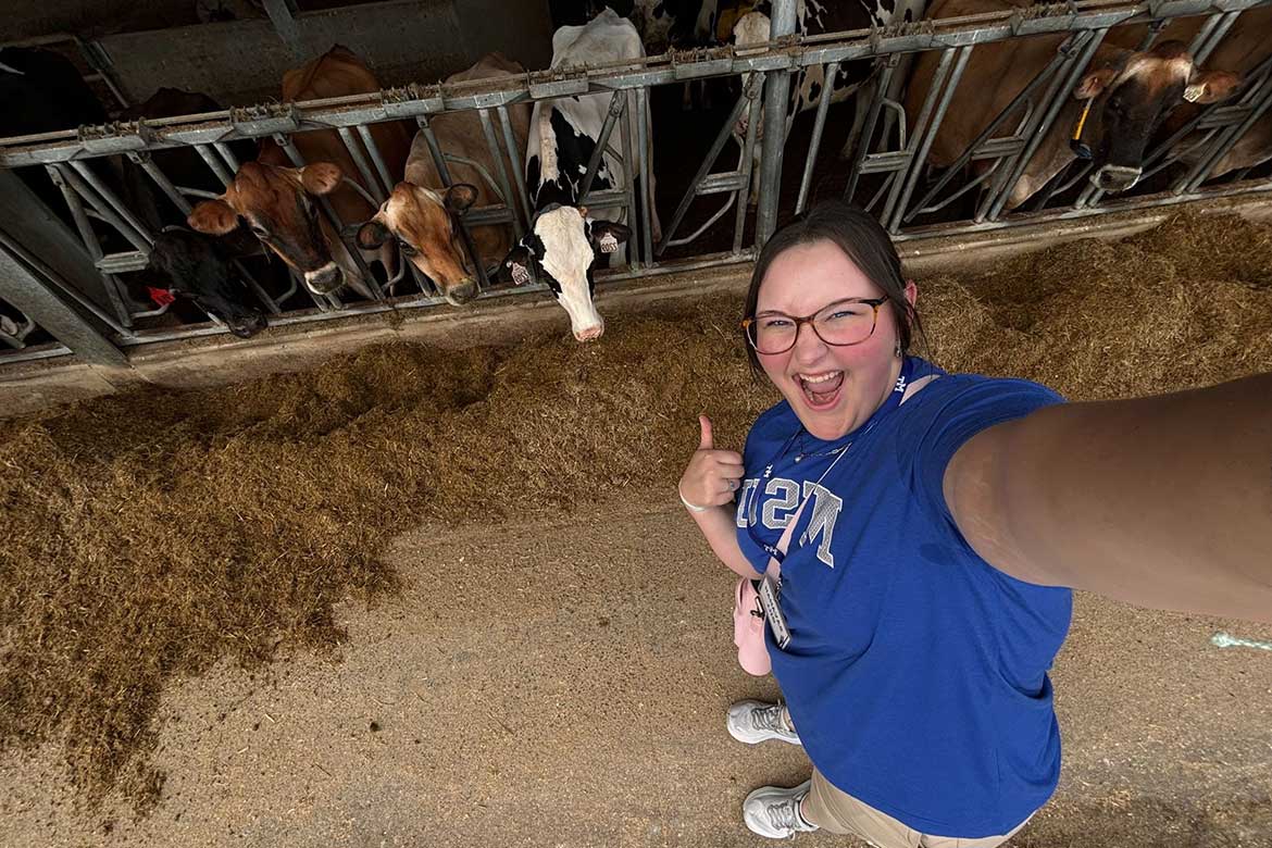 Savanah Gill takes a photo with Middle Tennessee State University's dairy cows at the farm located in Lascassas, Tenn. (Photo submitted)