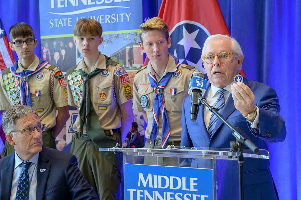 During a campus ceremony renewing the university's longstanding partnership with the Middle Tennessee Council of Scouting America, MTSU Board of Trustees member J.B. Baker, a former Council president and an Eagle Scout, shows a special Eagle Scout challenge coin that he carries daily in his pocket to remind him of the values of Scouting. (MTSU photo)