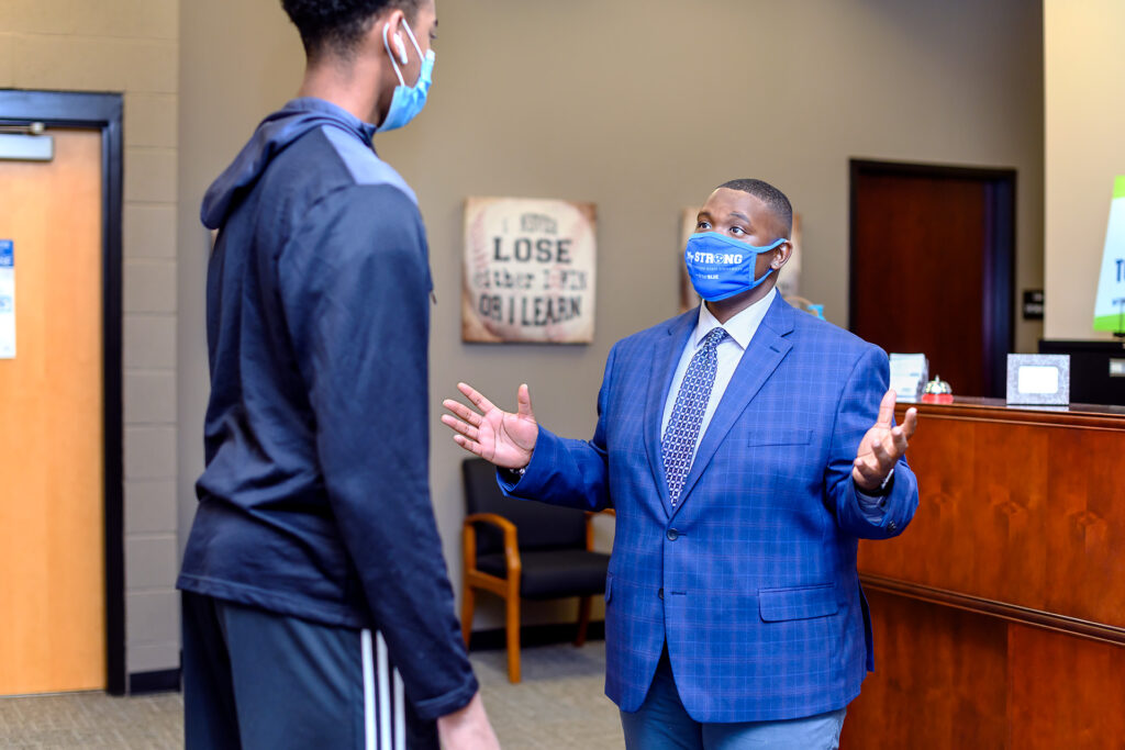 Travis Strattion, Student Success Assistant Manager of Scholars Academy with student Kalen Hodges. (Photo: J. Intintoili)