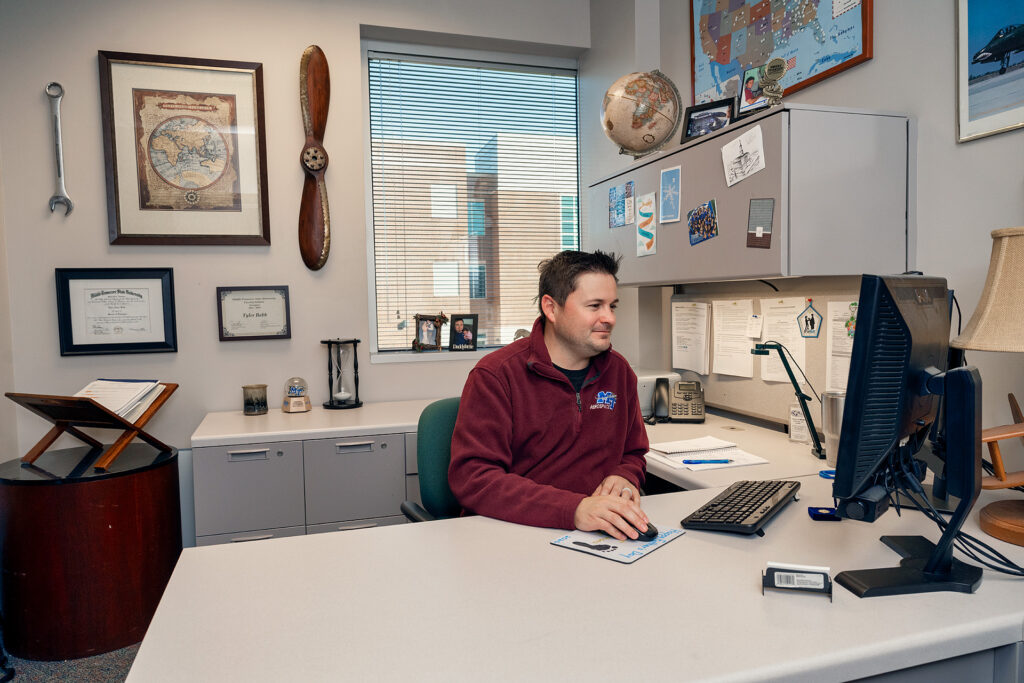 Tyler Babb, Professional Pilot Concentration Coordinator, Aerospace faculty in and around the Business and Aerospace Building. (Photo: Andy Heidt)