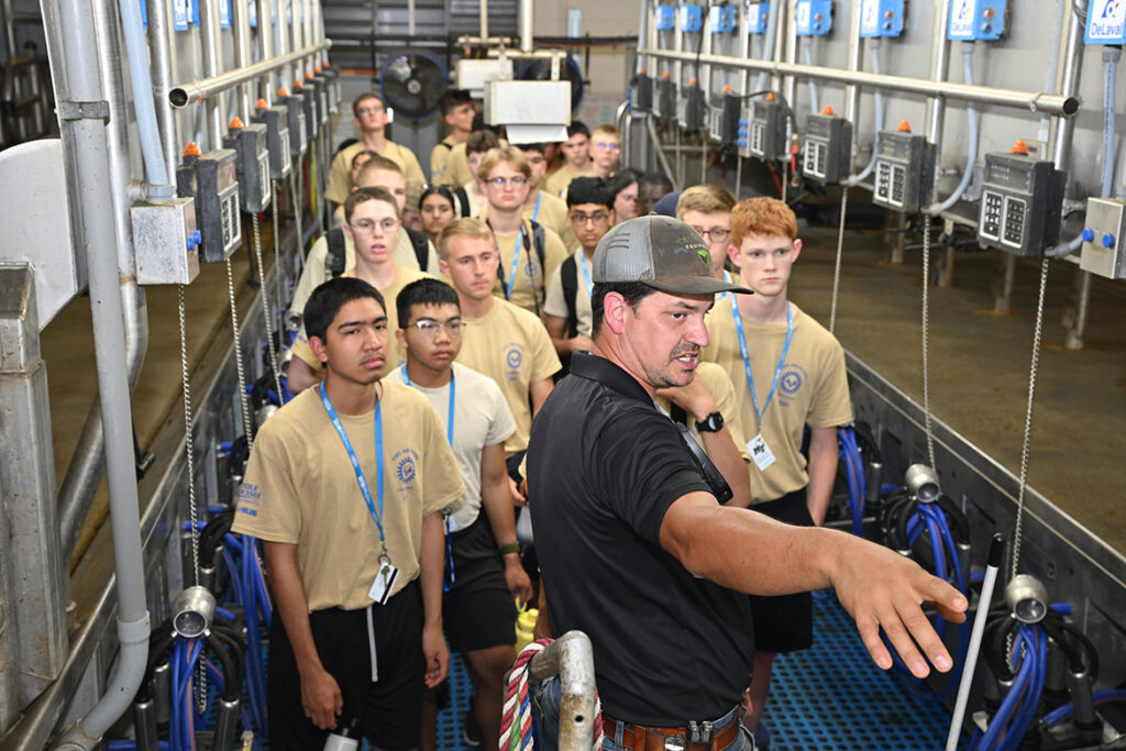 James Flatt, front, Middle Tennessee State University School of Agriculture Farm Laboratories director, points out specific areas of the MTSU Dairy at the MTSU Farm in Lascassas, Tenn., Tuesday, July 8, to a group of Civil Air Patrol participants attending the National Cadet Engineering Technology Academy at MTSU. (MTSU photo by James Cessna).
