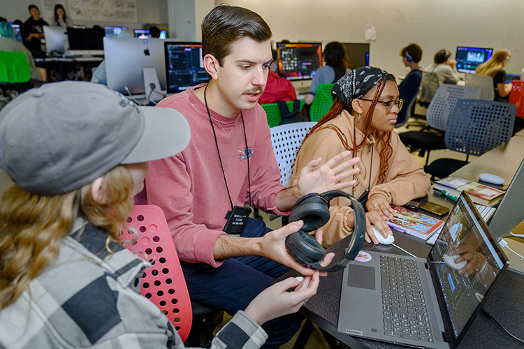 Filmmaker Christian Whittemore, center, an alumnus of the Tennessee Governor's School for the Arts filmmaking program, works with 2023 participants Sam Algood, left, and Savannah Burney in a Todd Hall classroom during the 39th annual event on the Middle Tennessee State University campus. Three hundred talented high school juniors and seniors traveled from across Tennessee to Murfreesboro in June for three-week residency programs in dance, film, the visual arts, theater and music and squeezed in a feel for college life, too. (MTSU photo by J. Intintoli)