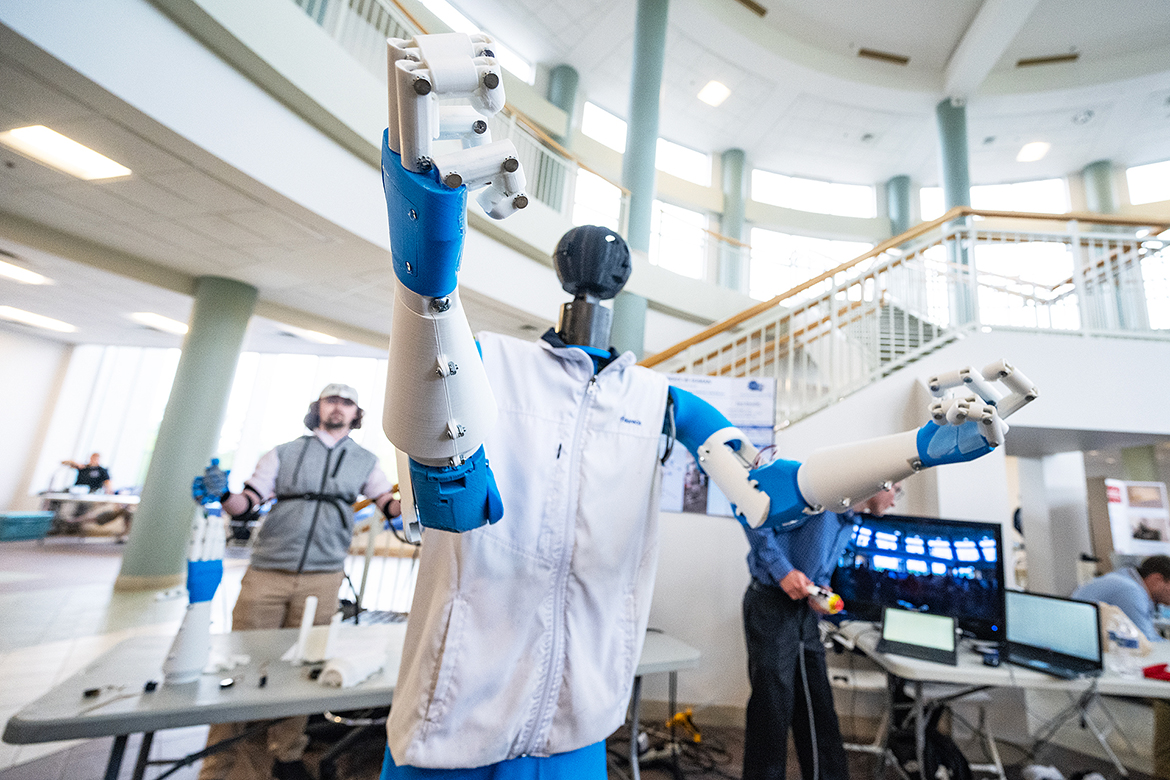 Wearing a tracking vest, May graduate Luke Maness of Lexington, Tenn., guides the robot, “Candice Be Human,” during the annual Middle Tennessee State University Mech-Tech, an expo for Engineering Technology and Mechatronics Engineering students held during study day. (MTSU photo by Cat Curtis Murphy)
