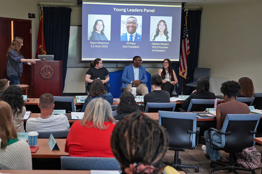 Middle Tennessee State University faculty member Kelly Manix, far left at lectern, assistant professor of management in the Jones College of Business, moderates a young leaders panel during MTSU’s Institute of Leadership Excellence this spring inside the Paul W. Martin Sr. Honors Building on campus in Murfreesboro, Tenn. Panelists, seated from left, are Taylor Shepherd, a 2203 institute alumna, R.J. Ware, Student Government Association president, and Natalie Stepien, president and founder of the Middle Tennessee Leadership Society.