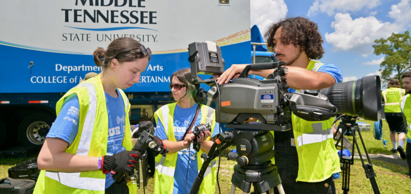 Students from the Media Arts Department at Middle Tennessee State University in Murfreesboro, Tenn., unload and prepare audiovisual equipment outside the university’s Mobile Production Lab on site at Bonnaroo.