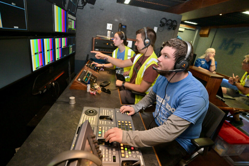 MTSU students inside mobile production lab working control board.