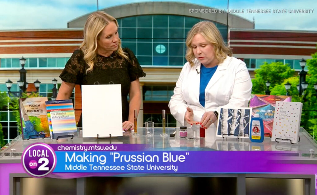 Sarah Pierce, right, a chemistry instructor at Middle Tennessee State University, appears on a recent “MTSU on 2” segment from WKRN-TV’s Nashville, Tenn., studios to talk about the unique history of Prussian blue and its many uses. At left is program host Stephanie Langston. (Screen capture from Local on 2 YouTube channel)