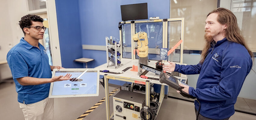Matthew Crist, right, director of Electronics Labs in the Engineering Technology Department at Middle Tennessee State University in Murfreesboro, Tenn., works with a student in one of the Applied Engineering Building labs used to train students in the mechatronics engineering program. (MTSU photo)