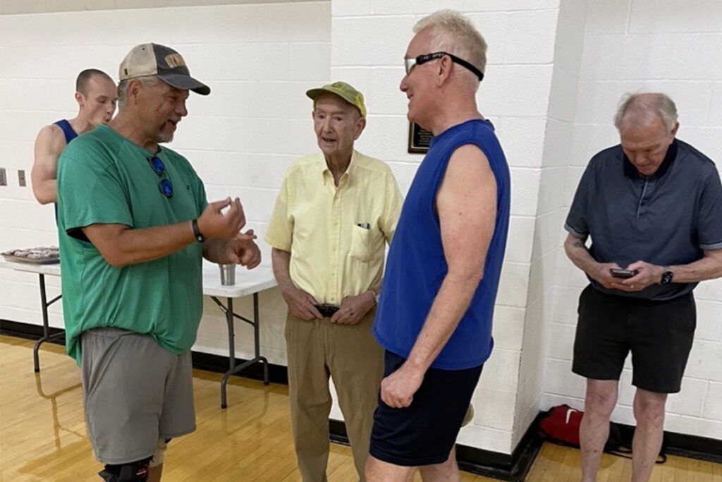 Retired longtime Middle Tennessee State University faculty member and senior Olympian basketball player Omri Rawlins, center, visits with fellow “Noon Basketball Association” members following a court dedication ceremony held in his honor at the Campus Recreation Center in Murfreesboro, Tenn. Faculty and staff members who played alongside Rawlins helped advocate for the recognition. (Submitted Photo)