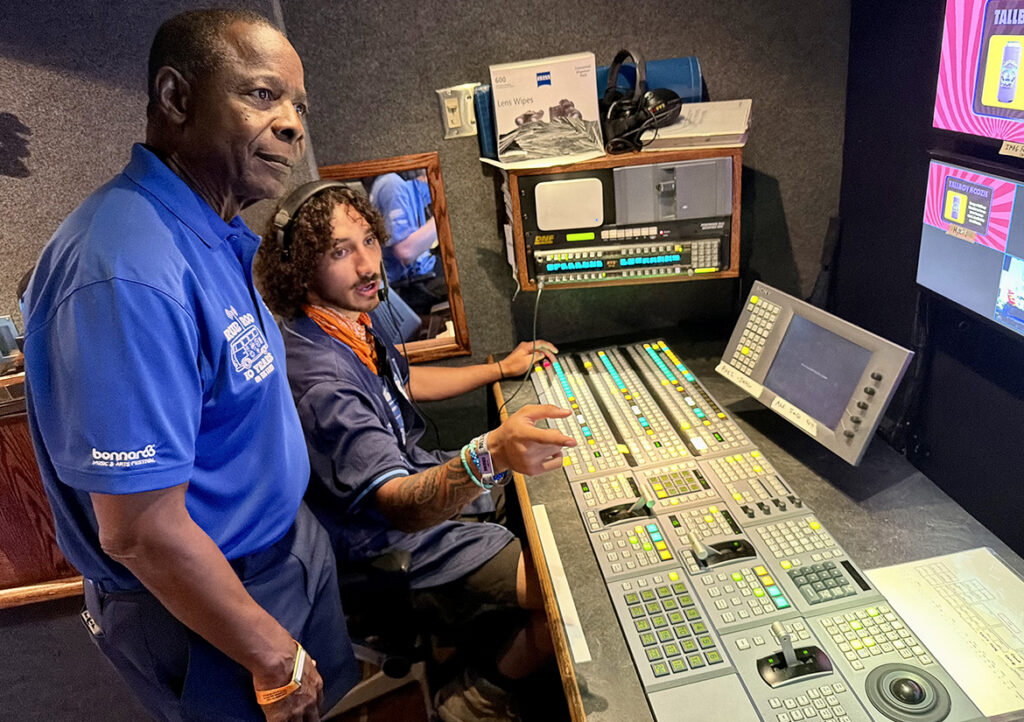 Sidney A. McPhee, left, president of Middle Tennessee State University in Murfreesboro, Tenn., listens as a student explains the video and production process inside MTSU’s Mobile Production Lab on site at the Bonnaroo Music and Arts Festival held June 11-14, 2026, in Manchester, Tenn. MTSU students directed broadcasts, operated cameras and managed audio for live events from the This Stage that were livestreamed on Hulu. (MTSU photo by Andrew Oppmann)