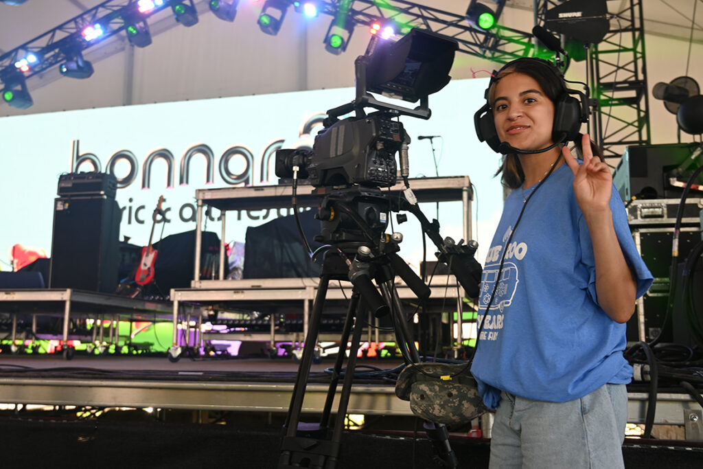 A video and film production student from Middle Tennessee State University in Murfreesboro, Tenn., prepares to capture a performance on the This Stage at the Bonnaroo Music and Arts Festival held June 11-14, 2026, in Manchester, Tenn. (MTSU photo by Andrew Oppmann)