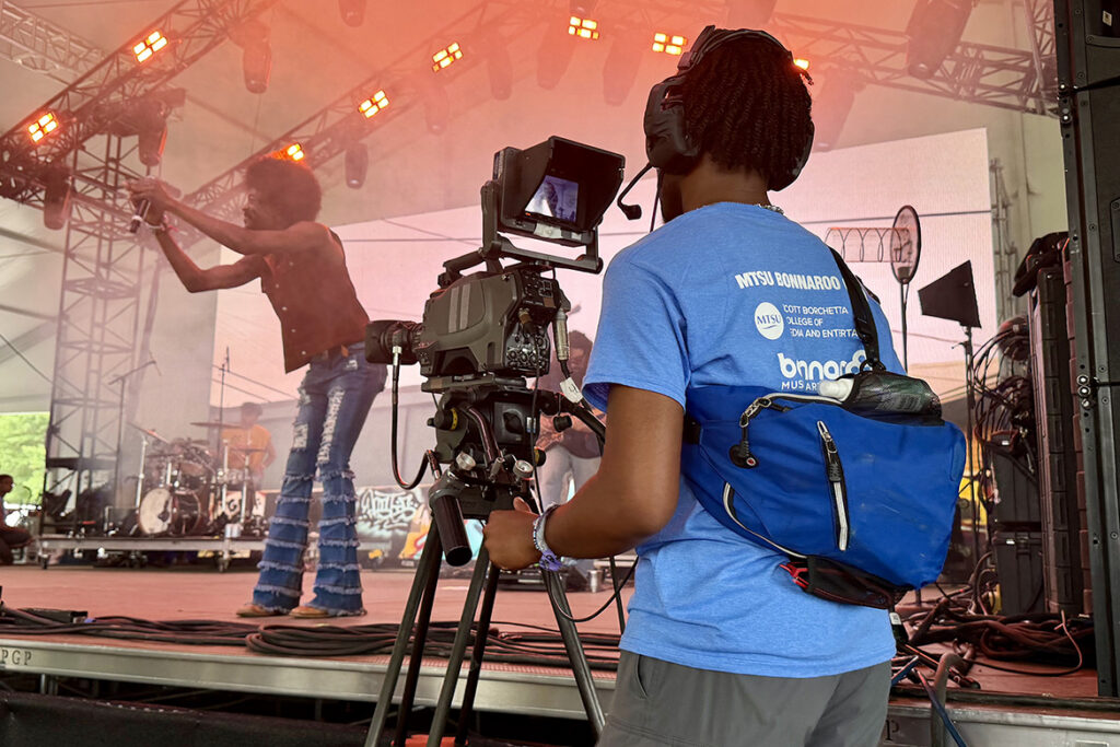A video and film production student from Middle Tennessee State University in Murfreesboro, Tenn., films a performance on the This Stage at the Bonnaroo Music and Arts Festival held June 11-14, 2026, in Manchester, Tenn. (MTSU photo by Andrew Oppmann)