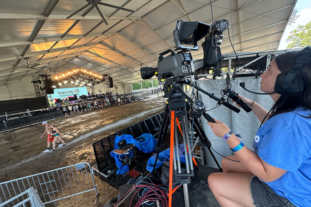 A video and film production student from Middle Tennessee State University in Murfreesboro, Tenn., gets a camera set up and prepares to capture a performance on the This Stage at the Bonnaroo Music and Arts Festival held June 11-14, 2026, in Manchester, Tenn. after a weather evacuation. (MTSU photo)
