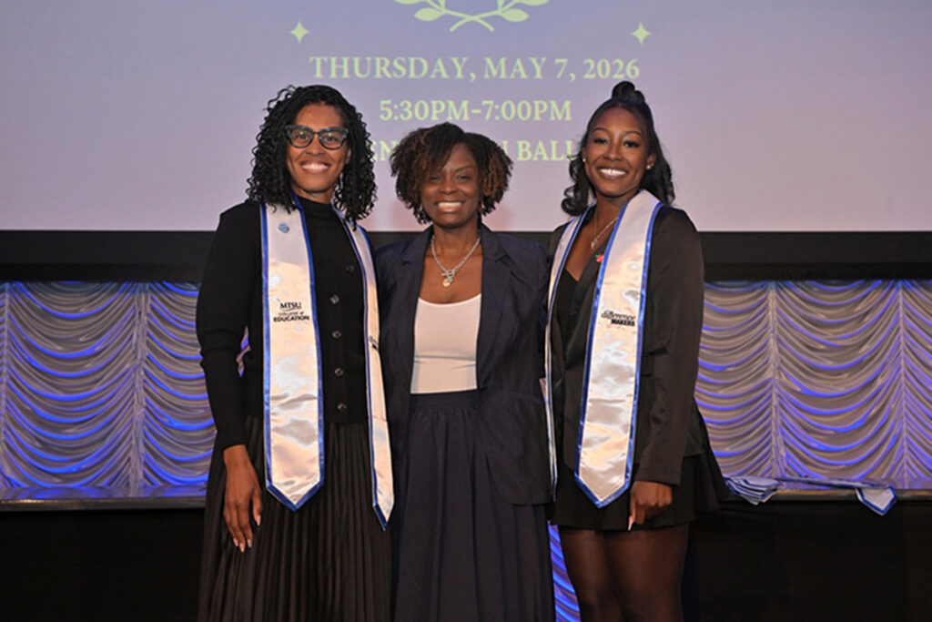 Middle Tennessee State University education graduates Ayana Samuel, left, and daughter Autumn Claybrooks, right, smile for a photo with Neporcha Cone, dean of the university’s College of Education, at the college’s Pinning and Stole Ceremony on May 7, 2026, at the Student Union Ballroom on campus in Murfreesboro, Tenn. (Submitted photo).