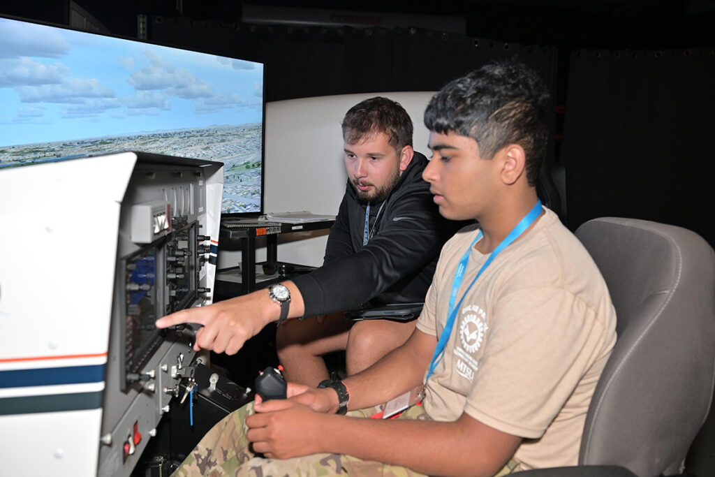 A Civil Air Patrol cadet in the U.S. Air Force Auxiliary’s National Cadet Engineering Technology Academy held July 18-25, 2026, held July 18-25, 2026, at Middle Tennessee State University in Murfreesboro, Tenn., uses one of the Department of Aerospace’s flight simulators under the watchful eye of a flight instructor. (MTSU Photo by James Cessna)