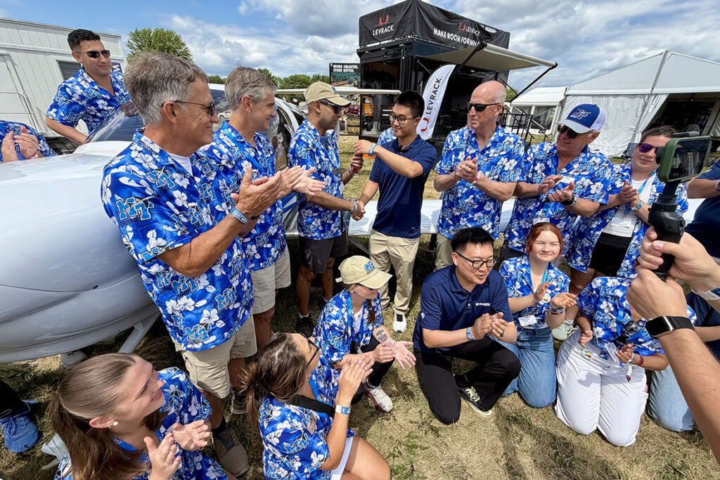 Chaminda Prelis, chair of Middle Tennessee State University’s Aerospace Department, center left, accepts the keys to a new Diamond Aircraft DA-40, which will become the 41st Diamond aircraft in the training fleet. The aircraft was presented to MTSU by Diamond during a July 22, 2026, ceremony at the 2026 EAA AirVenture in Oshkosh, Wis., also attended by Provost Mark Byrnes, front left, standing; Basic and Applied Sciences Dean Greg Van Patten, right of Byrnes; and Trustee Jimmy Granbery, right of center. (MTSU Photo by Andrew Oppmann)