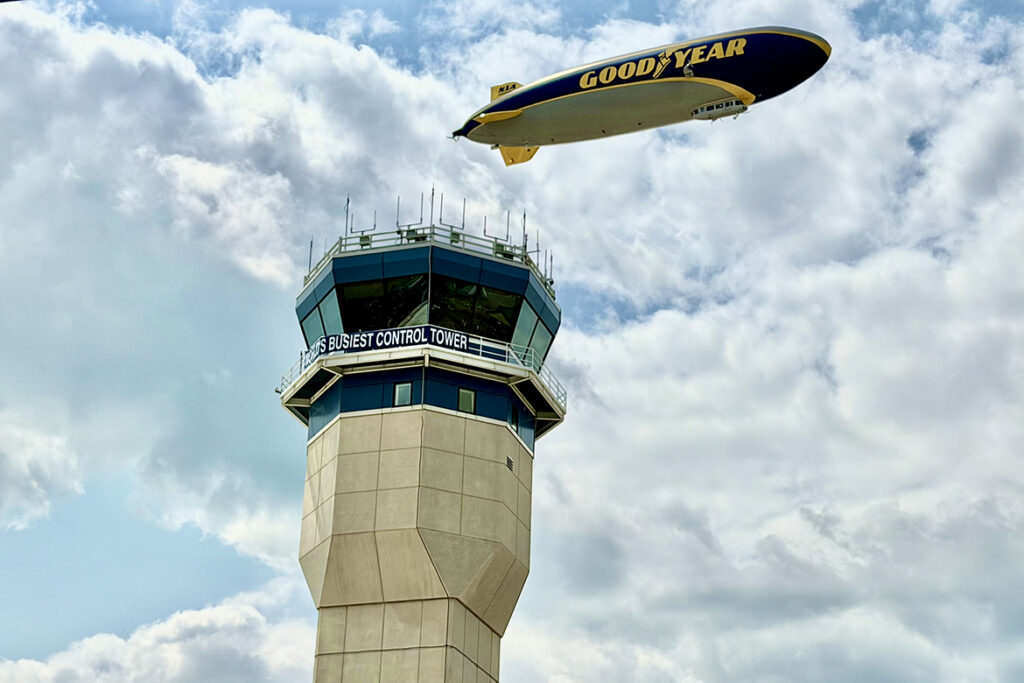The Goodyear Blimp flies near the control tower at Wittman Regional Airport in Oshkosh, Wisc., during the 2026 EAA AirVenture held in late July 2026 in Oshkosh, Wisconsin (MTSU Photo by Andrew Oppmann)