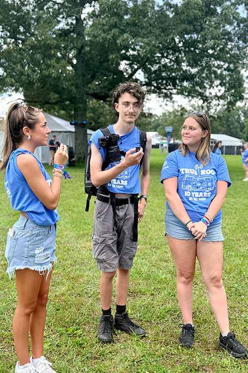Makaylee Hall, left, interviews two students from Middle Tennessee State University's student-run newspaper Sidelines at Bonnaroo Music and Arts Festival in Machester, Tenn., June 11-14, 2026. (Submitted photo)